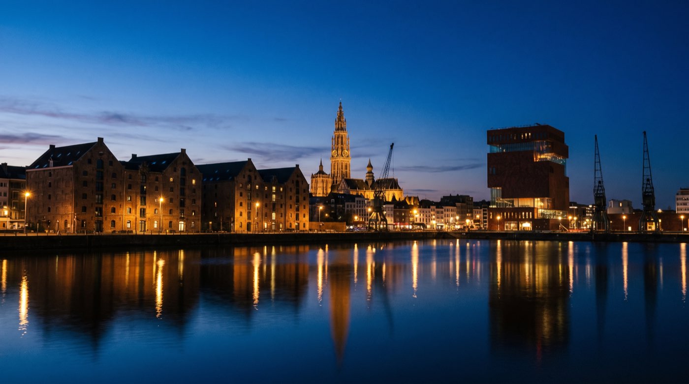 Illustration: the Antwerp waterfront at dusk with the cathedral and the MAS museum